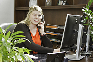 student on phone at desk
