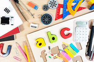 Close up of alphabet board game and basic equipment for elementary grade student for learning and playing. Wooden ABC alphabet game concept.